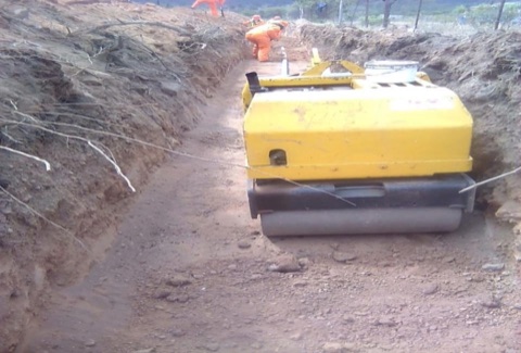 Roller compacting a trench backfill on a Mocheku Landscapers roads project
