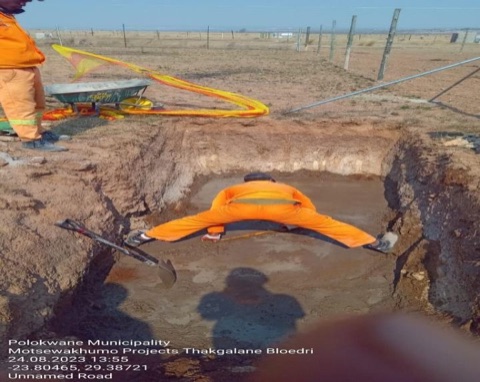 Worker fitting a sanitation pipe joint on the Thakgalane Bloedri project